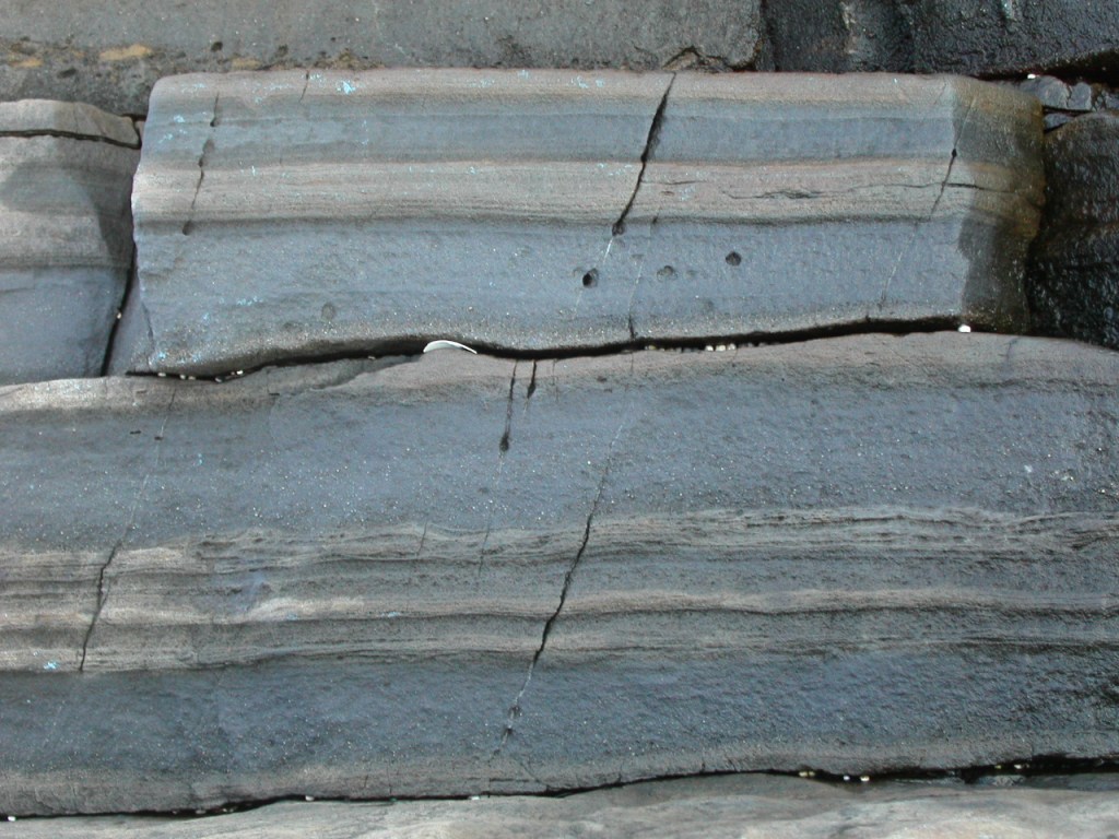 Layered dark rock strata close-up